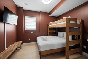 A bunk bed room with a wooden bench, a flat-screen TV, and a window with blinds. - Spacious Homes w/ Hot Tubs near Ark Encounter, Parking (Dry Ridge)