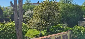A garden with trees and a building in the background. - New Listing (Malchow)
