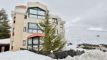 A multi-story building with a modern design, featuring large windows and a brick facade.