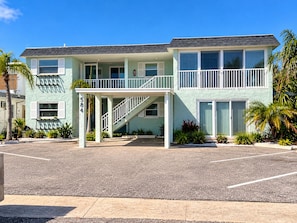 A two-story building with a covered entrance and a staircase leading to the second floor. - Cozy 1BR Beach Retreat. Just Blocks from Clearwater Beach (Clearwater)