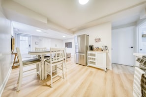 Een moderne keuken met een eethoek, roestvrijstalen apparatuur en een koffiehoek.