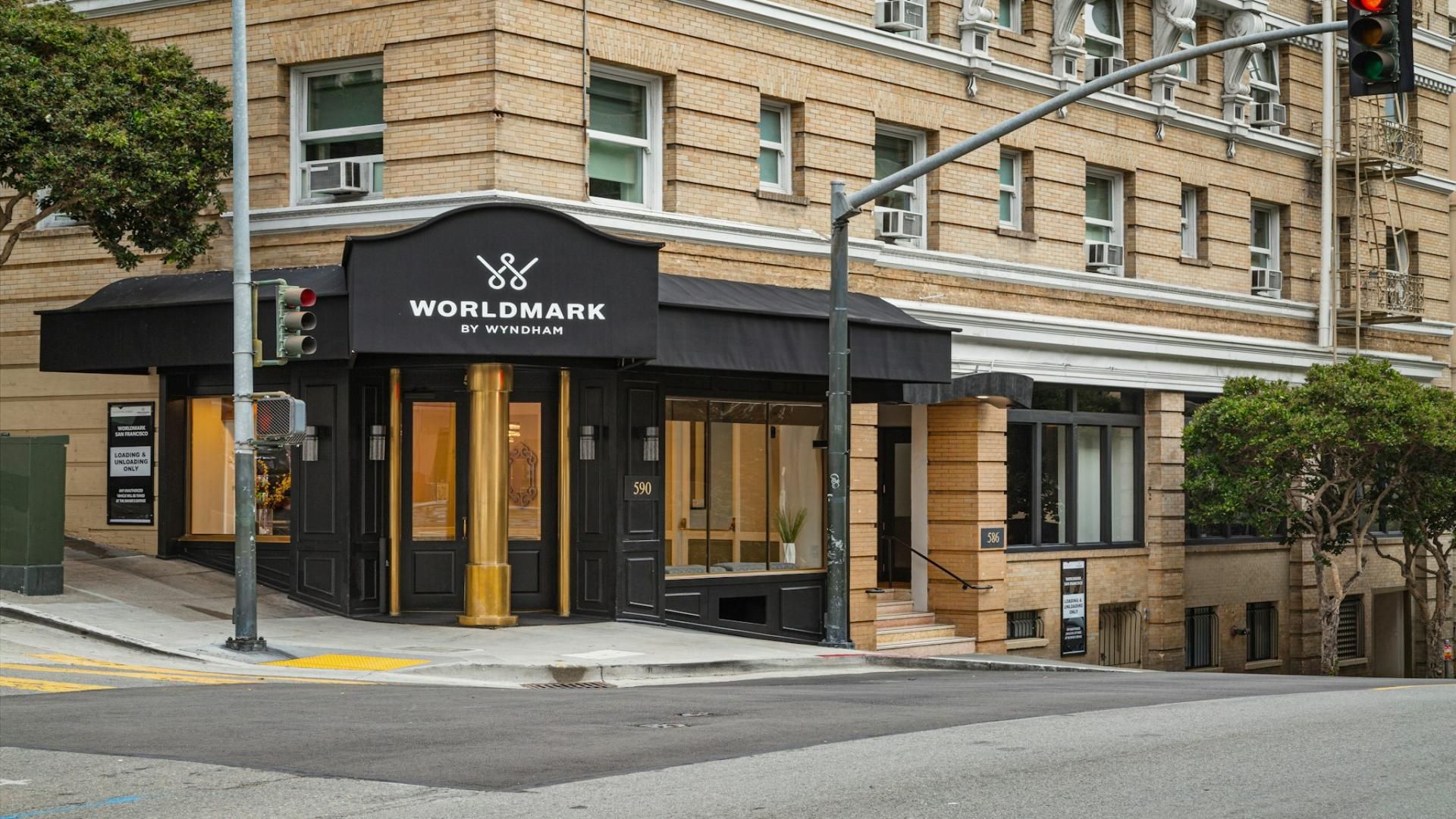 A building with a black awning and a sign that reads 'WORLDMARK BY WYNDHAM'.