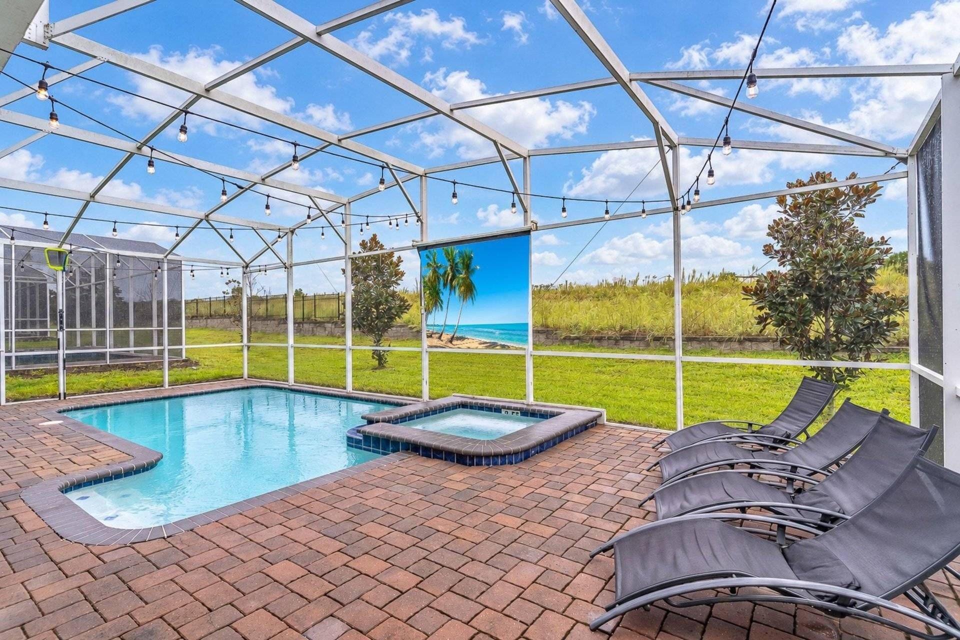 A covered outdoor swimming pool with lounge chairs and a view of the beach.