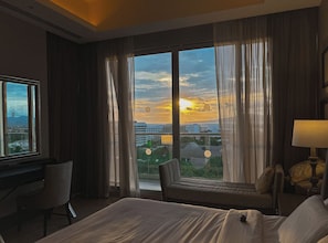 A hotel room with a large window, a bed, a chair, and a desk. - PGA Open and Luxury Living in a 3 Bedroom Suite in sunny Mexico! (Nuevo Nayarit)