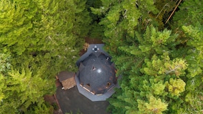 An octagonal gazebo with a roof, surrounded by dense green forest. - Hidden Dome Retreat in the Trees (Coos Bay)