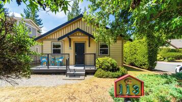 A single-story house with a front porch, a mailbox, and a well-maintained lawn.
