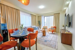 A well-lit living room with a dining area, a sofa, and a coffee table. - 16th Floor Luxury -GTC Skyline Views with gym and workspace (Nairobi)