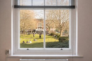 Views of the green square outside and Brick Lane- a peaceful outlook in the heart of Shoreditch - Design-Led Shoreditch Flat | Graffiti • Brick Lane (Greater London)