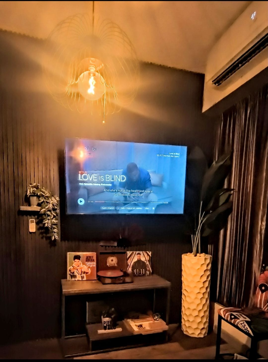 Living room with television, games, vinyl record player, AC and more.