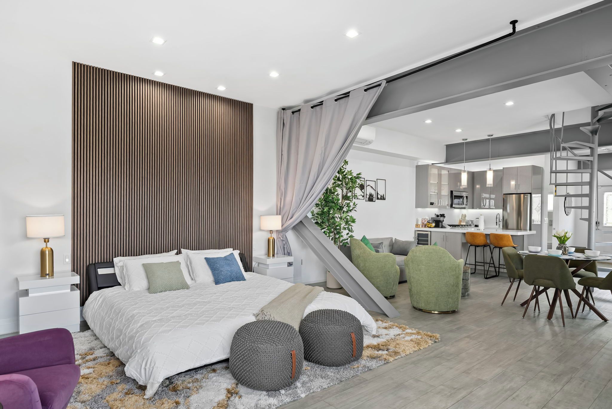 A modern bedroom with a bed, bedside tables, a nightstand, a desk, and a chair.