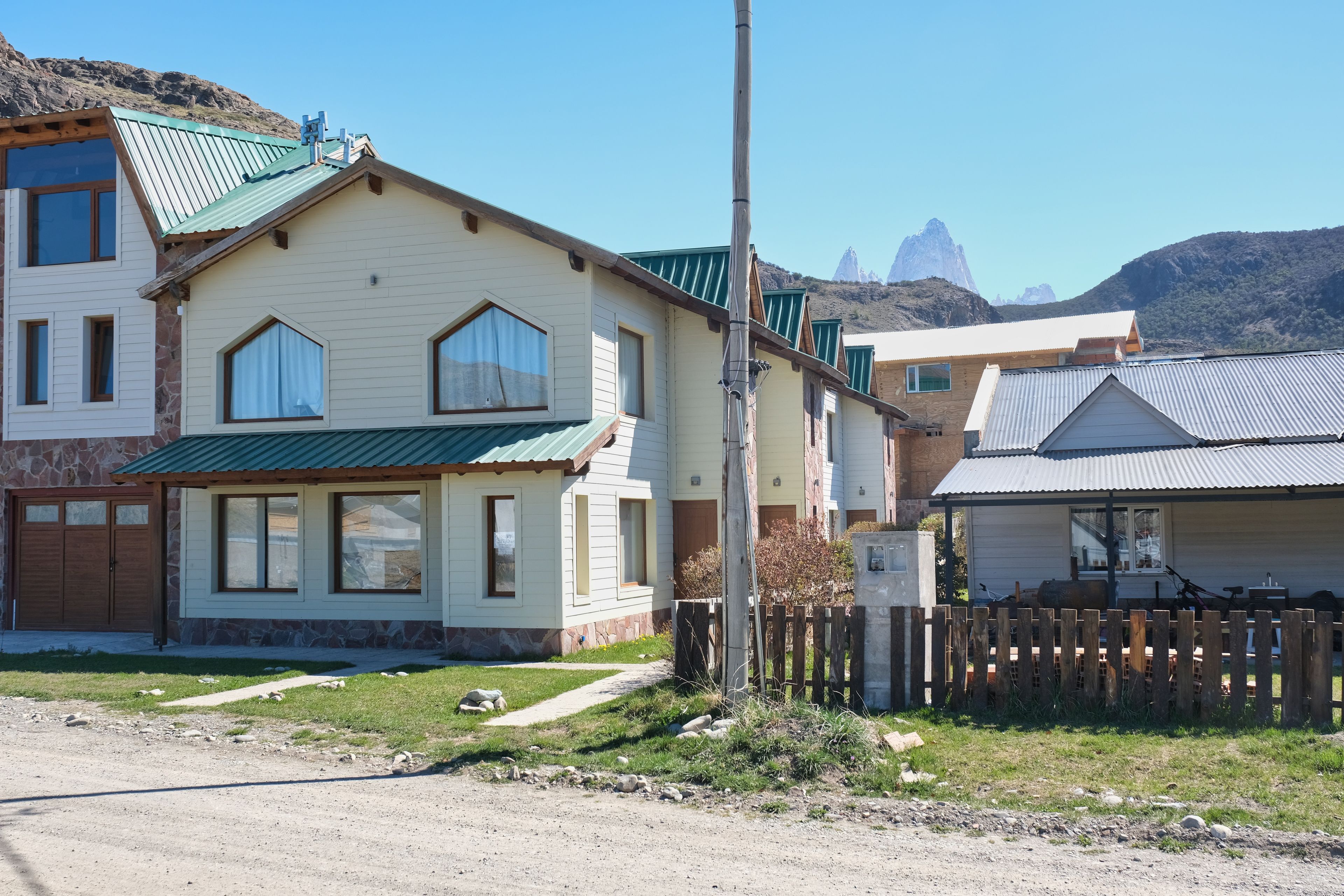 Zona residencial con casas de techo a dos aguas y cimientos de piedra.