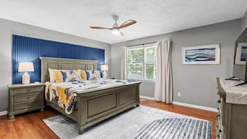 Close the door and rest. Dark wood bed, floral quilt.