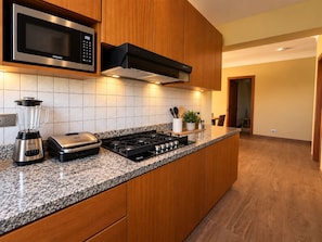 A modern kitchen with a built-in microwave, toaster, and gas stove. - New Listing (Jarabacoa)