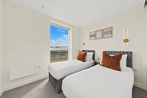 A hotel room with two beds, a large window, and a balcony. - The Masson Terrace | 3-Bed | Parking & Kew Gardens (Greater London)