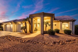 A two-story house with a garage, a covered patio area, and a landscaped driveway. - NEW|The Beaumont @ Bainbridge|Heated Pool|FirePit (Fountain Hills)