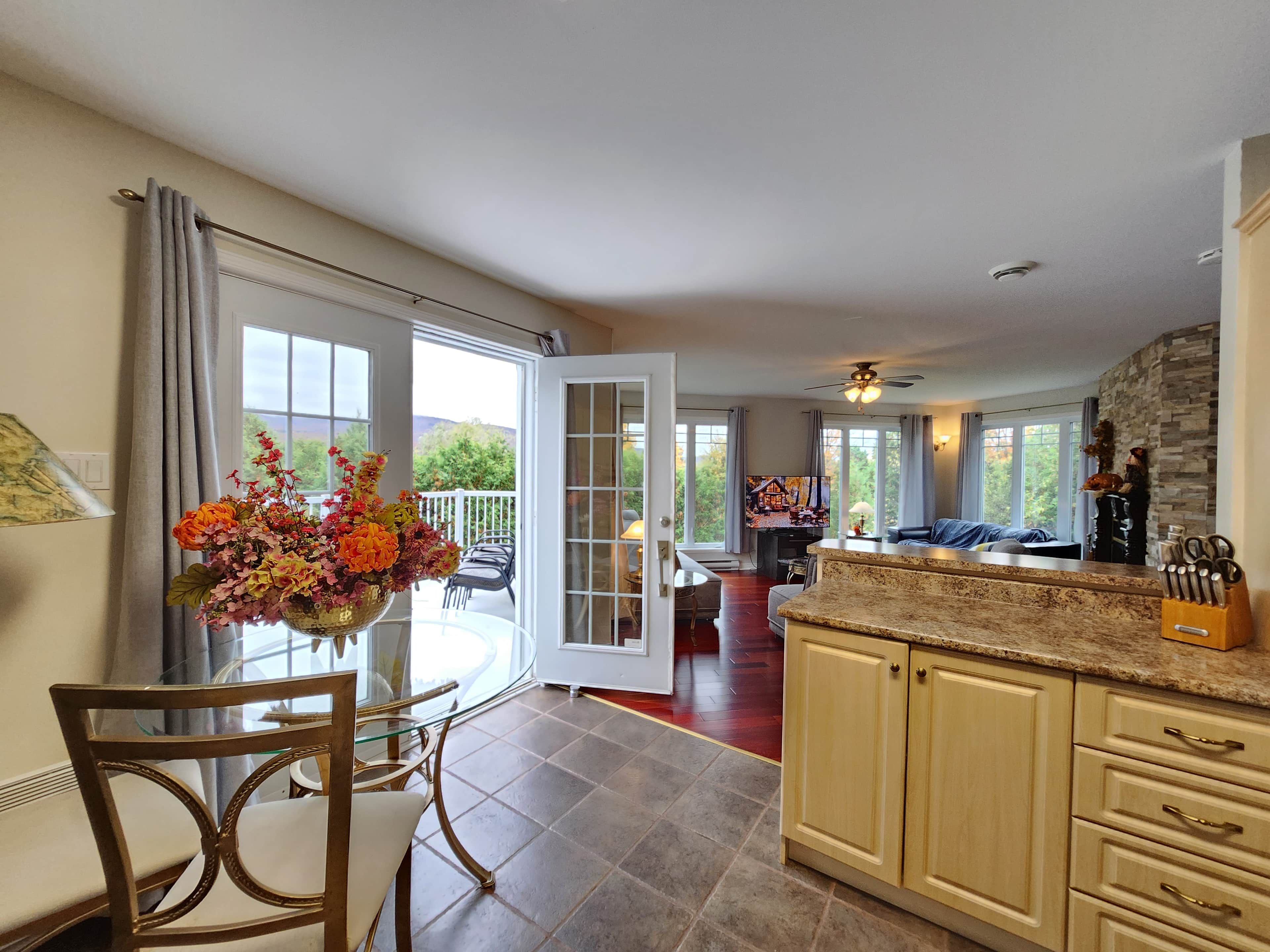 A spacious kitchen with a dining area, a large window, and a view of the outdoors.