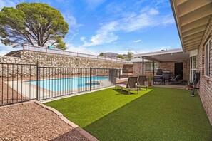A backyard with a swimming pool, artificial grass, and outdoor furniture. - El Paso Desert Oasis (El Paso)