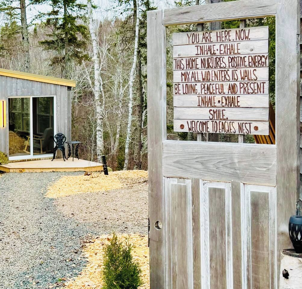 A wooden sign with a welcoming message for Eagles Nest.