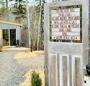 A wooden sign with a welcoming message for Eagles Nest. - Eagle’s Nest Nature Retreat•Shine & Rise Wellness (Saint Mary Parish)