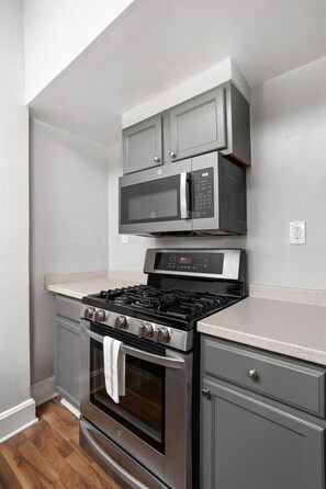 A kitchen with a built-in gas stove, microwave, and oven. - The Sea Turtle - Private Studio, Walk to Mass Ave (Indianapolis)