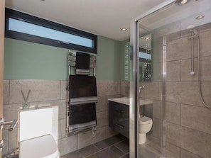 A modern bathroom with a glass shower enclosure, a toilet, and a sink. - Whispering Reeds, Hot Tub and Private Quay, Horning (Horning)