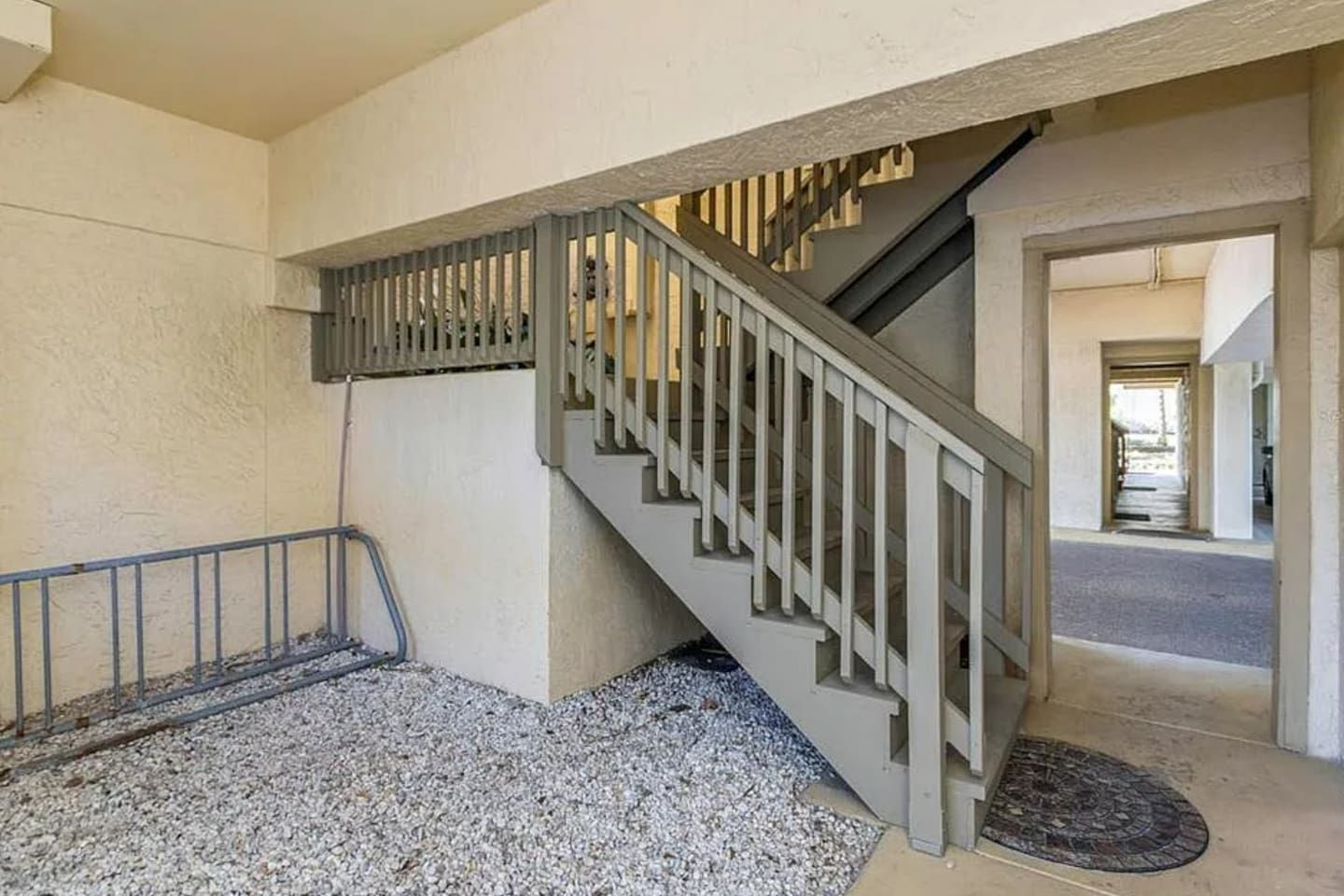 A staircase with a metal railing leading to an upper floor.