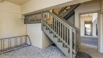 A staircase with a metal railing leading to an upper floor.