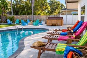 A pool area with lounge chairs and a fire pit. - Clearwater Fun House, Games, Heated Pool, Hot Tub Sleeps12 (Clearwater)
