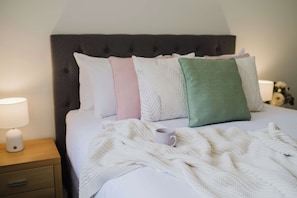 A neatly made bed with a white comforter and a knitted throw blanket. - Paradise Lake Conjola Park - Wake up to ocean views (Conjola Park)