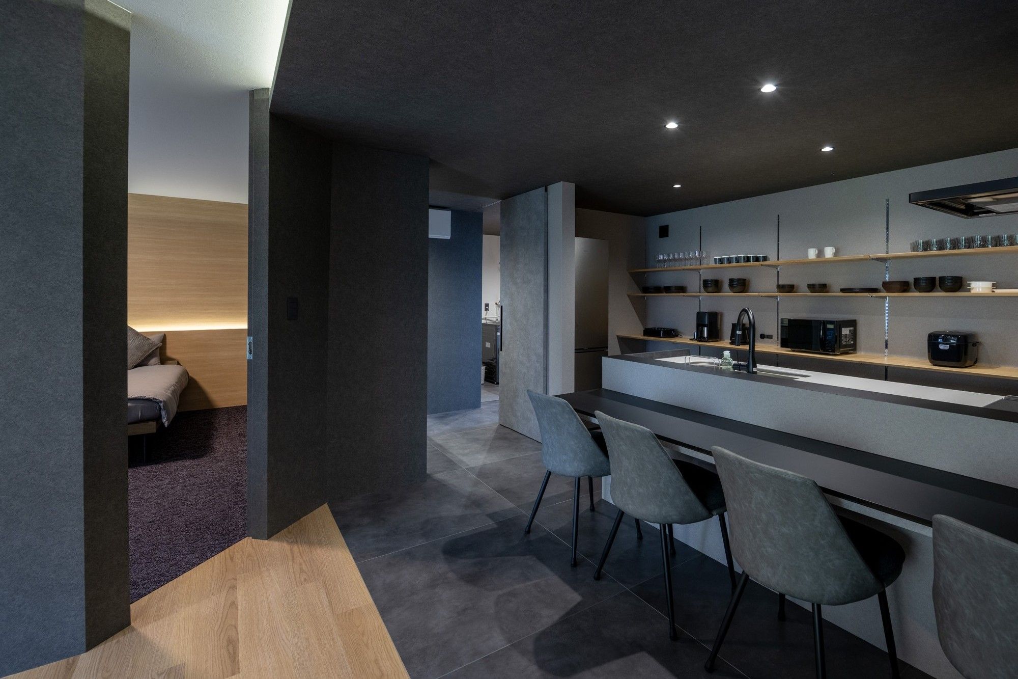 A modern kitchen with a central island, bar seating, and built-in appliances.