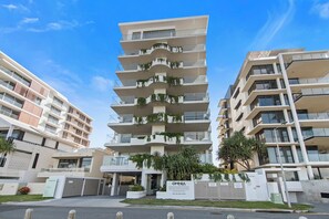 A multi-story residential building with balconies, a gated entrance, and a sign indicating 'OMNIA PALM BEACH.' - The Esplanade, Palm Beach (Palm Beach)