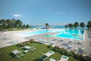 A resort with two large swimming pools, sun loungers, and a water slide. - Mobile home with air conditioning, terrace and pool (Umag)