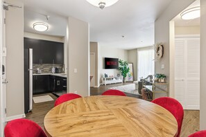 A modern kitchen with dark cabinets, a stainless steel refrigerator, and a tiled backsplash. - Charming 2-bedroom apartment with pool, gym and free parking in Marina del Rey! (Marina del Rey)
