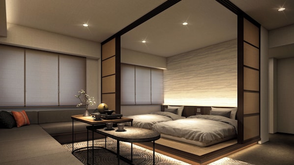 A modern bedroom with a bed, sofa, and a small table with a lamp.