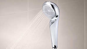 A chrome showerhead with water flowing from it. - Minn Kyoto Shijo (Kyoto)