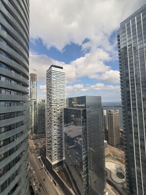 A high-rise building with a curved facade and a large glass window. - Toronto in the Sky | CN Tower & Lake Views (Toronto)