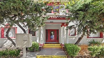A building with a red door and a number 460 sign above it.