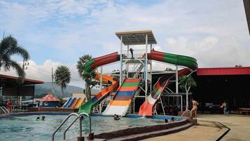 A water park with multiple slides and a pool area.