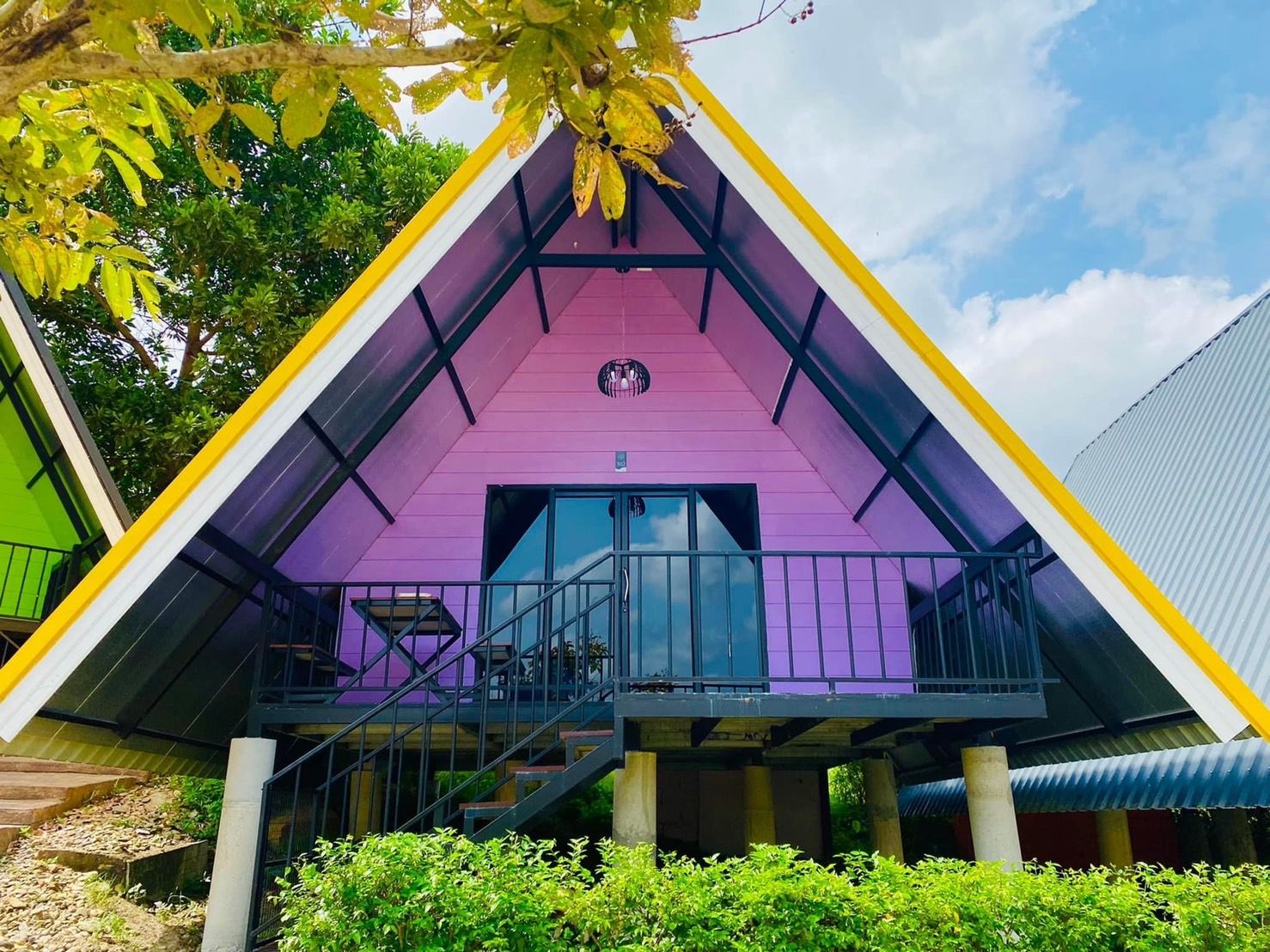 A building with a triangular roof and a balcony.