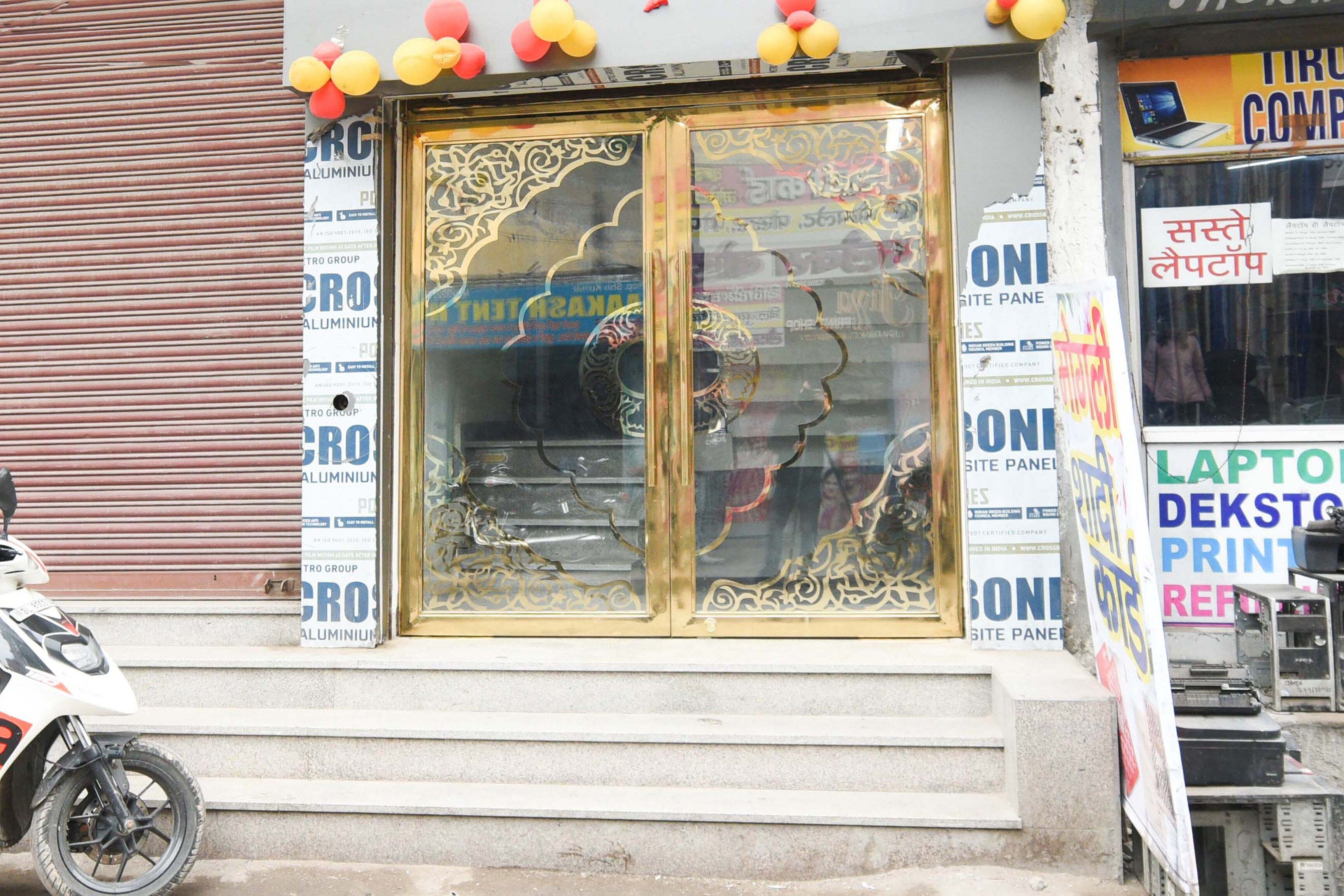 A storefront with a large glass door, surrounded by various advertisements.