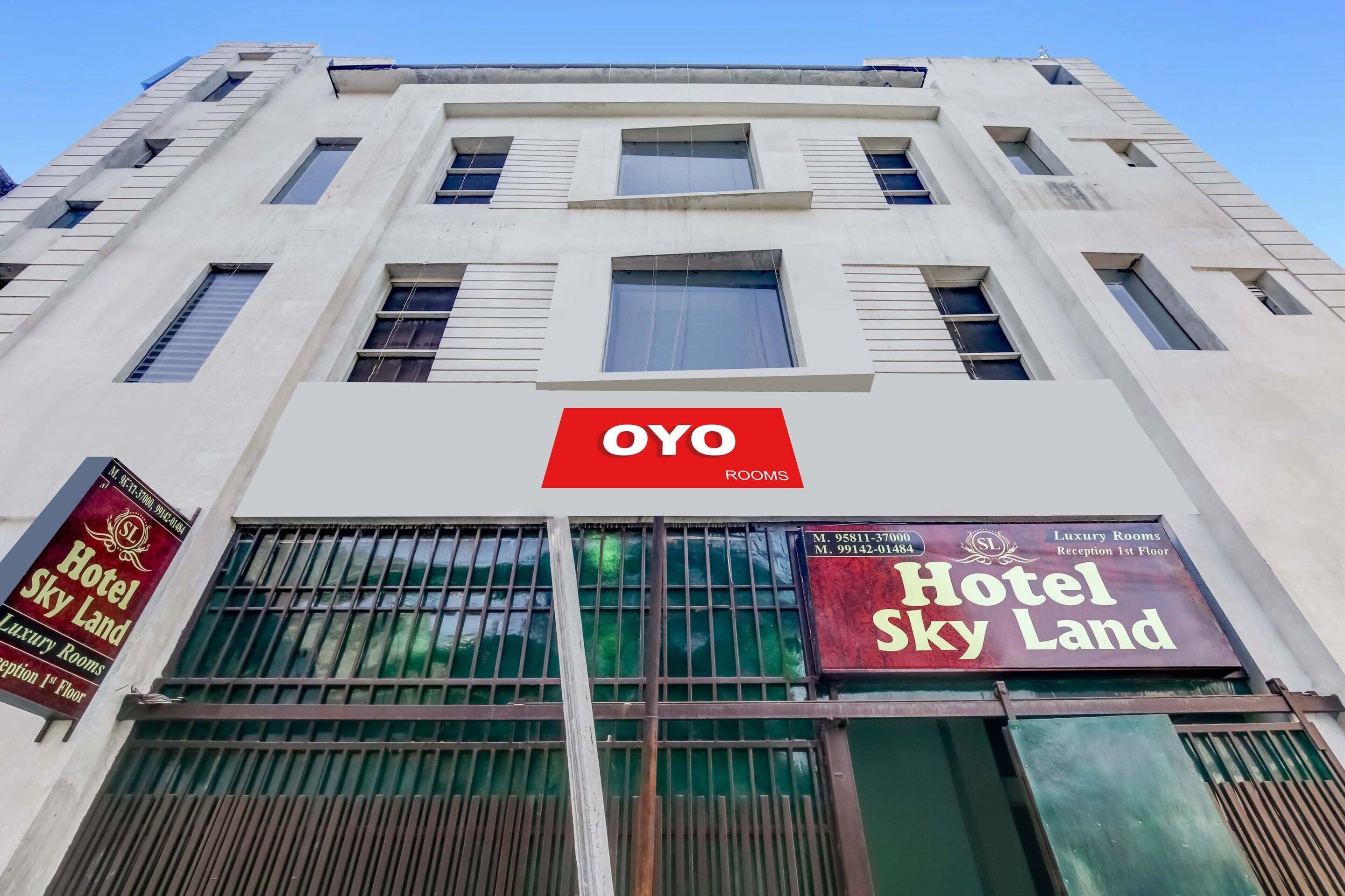 A hotel building with a prominent 'OYO ROOMS' sign.