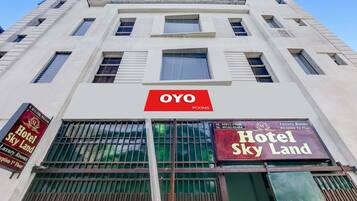 A hotel building with a prominent 'OYO ROOMS' sign.