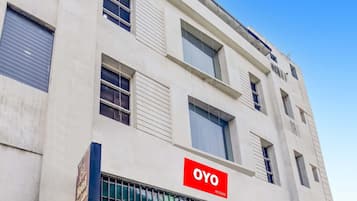 A building with a sign for 'OYO Rooms' indicating hotel accommodation.
