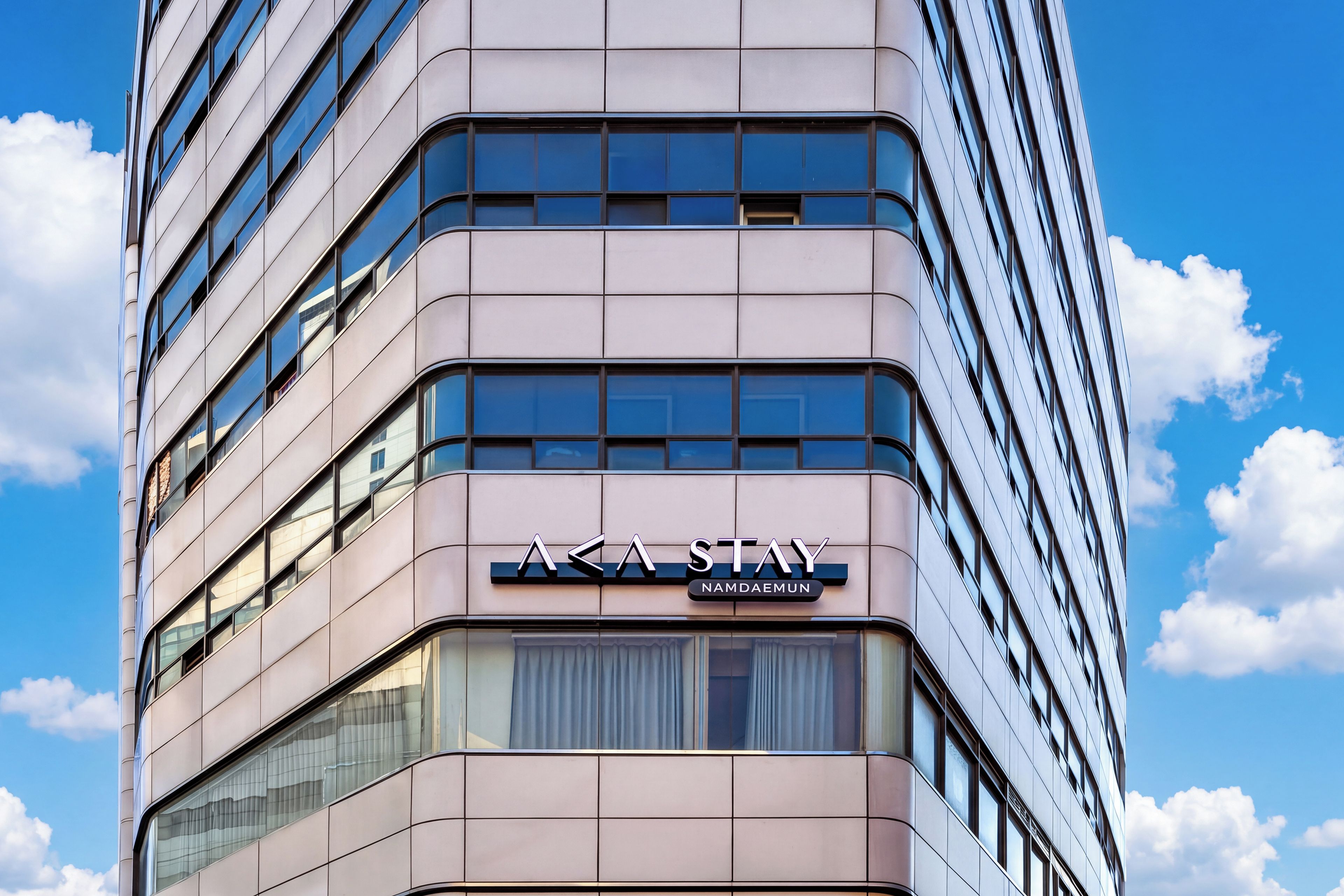 A modern building with a sign reading 'A Stay Nam Daemun'.