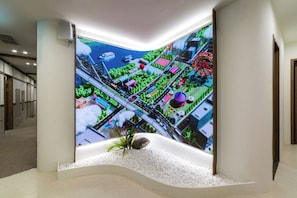 A modern interior with a curved wall displaying a vibrant cityscape mural.