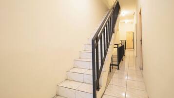 A staircase with a metal railing leading to a landing.