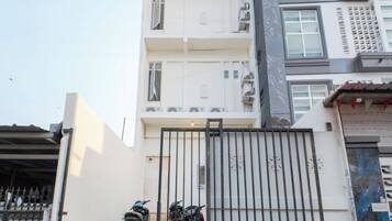 A gated entrance with a motorcycle parked inside.