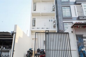 A gated entrance with a motorcycle parked inside. - Tamastu House Grogol (Jakarta Barat)