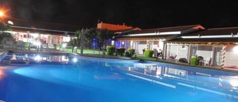 A swimming pool with a clear view of the adjacent hotel building.