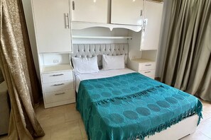 A bedroom with a bed, a nightstand, a dresser, and a wardrobe. - Chalet with side sea and pool view, Turtles Beach (Hurghada 2)